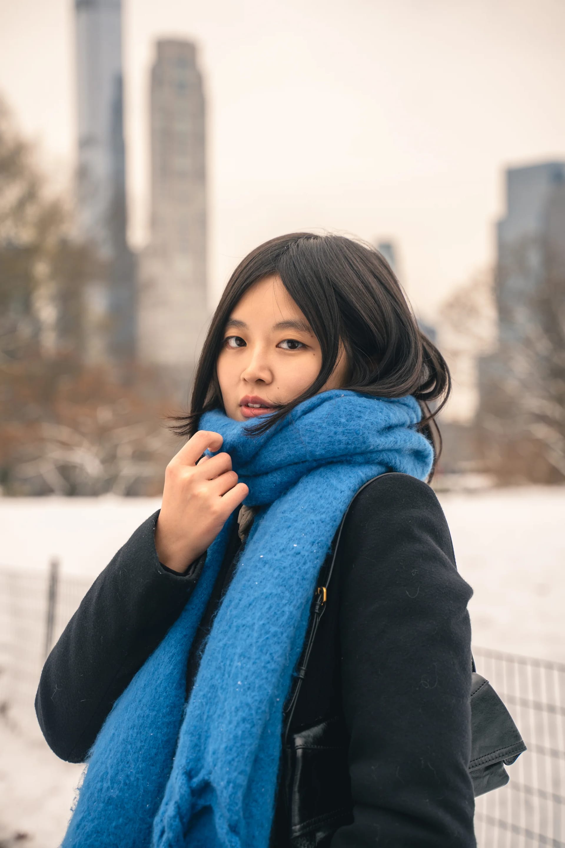 A close portrait framed by a bright blue scarf