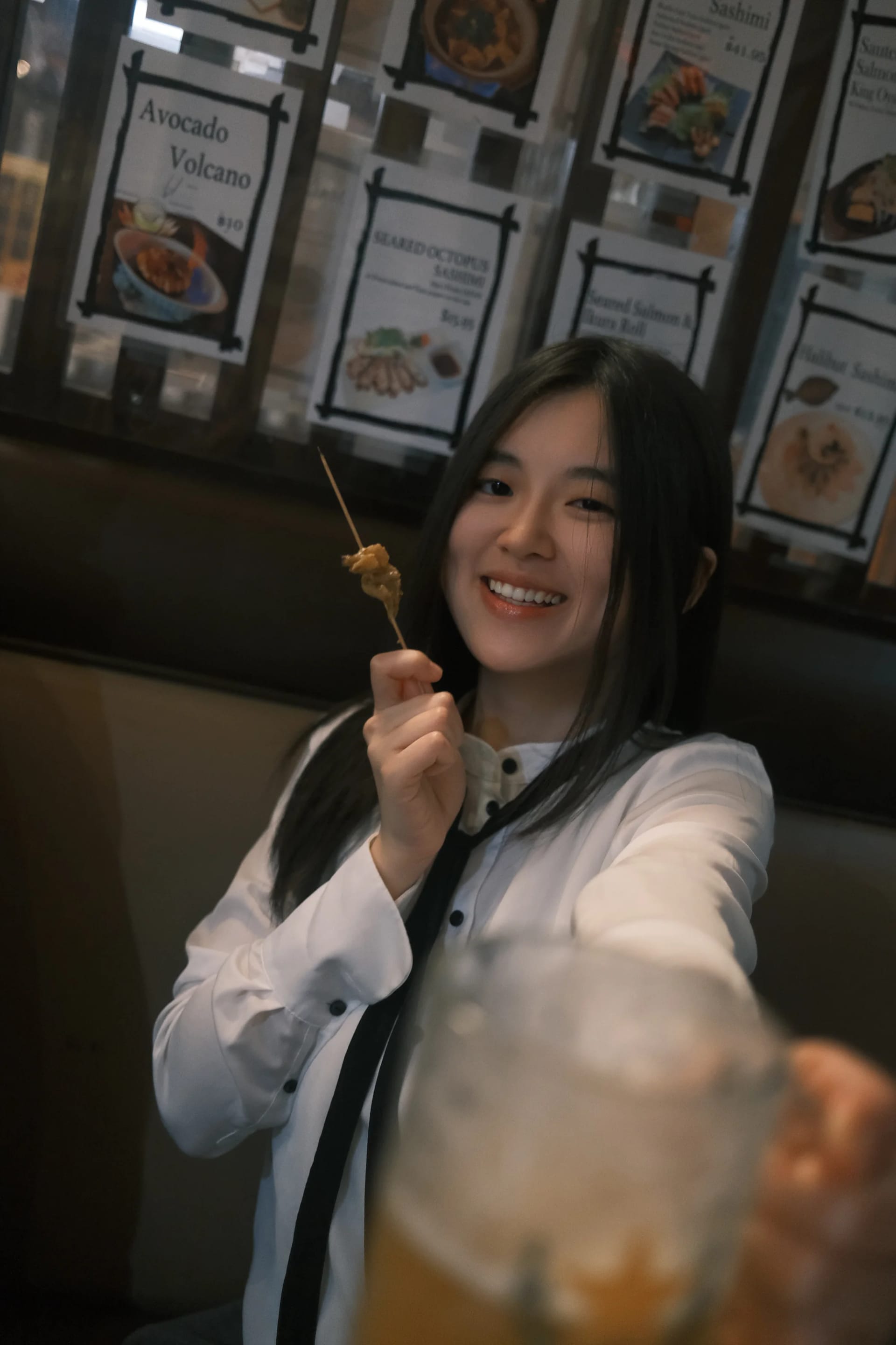 A diner looking toward the camera across a restaurant table