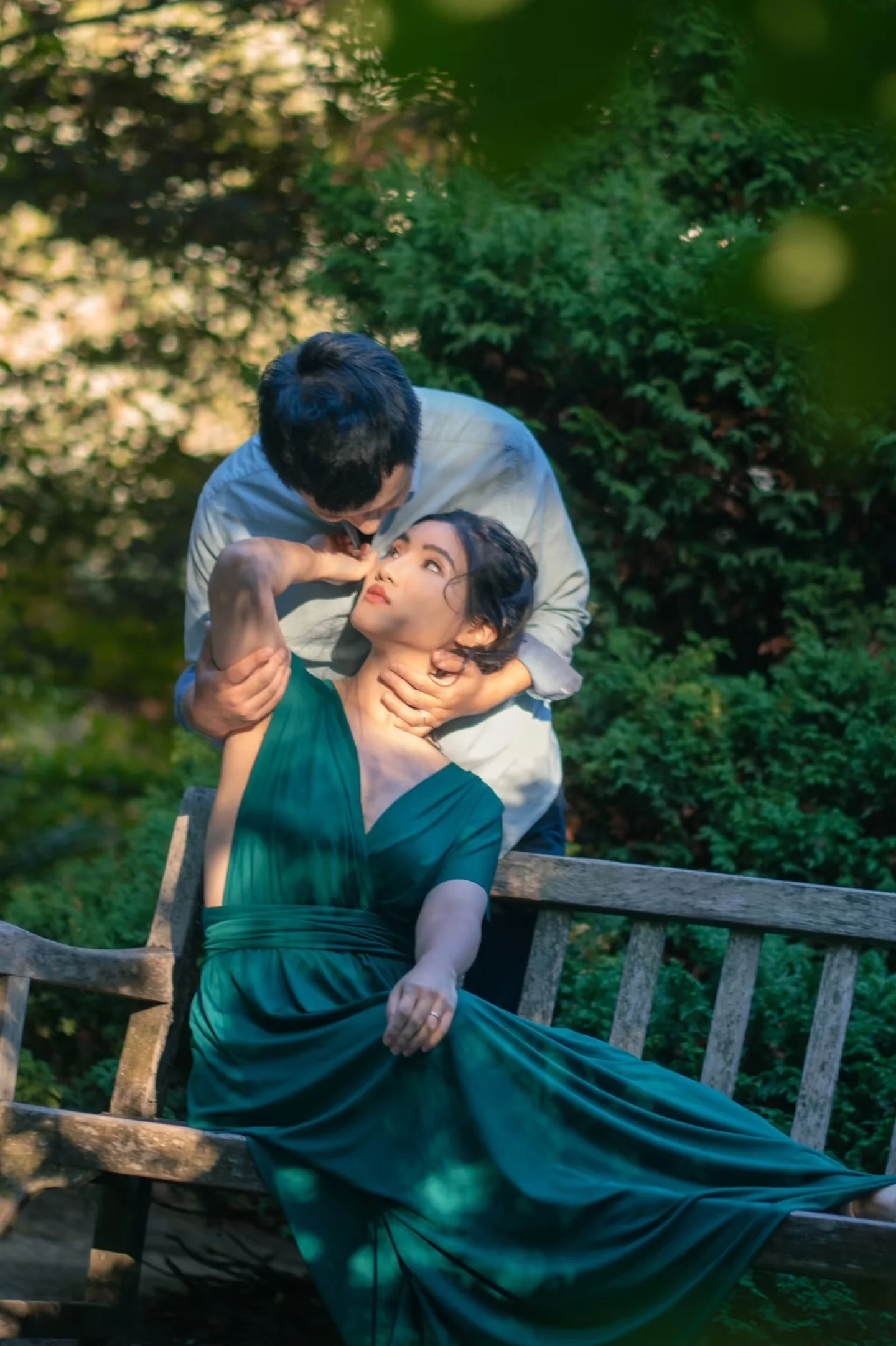 An overhead portrait of a couple sharing a quiet moment on a garden bench